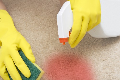 Technician preparing carpet cleaning equipment safely before a job